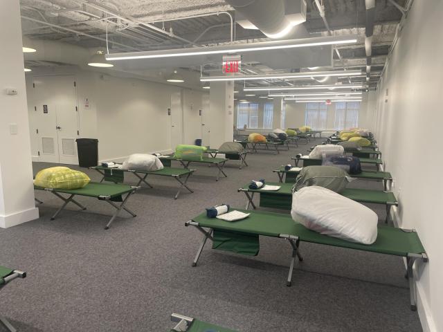 cots set up at a shelter in fort point