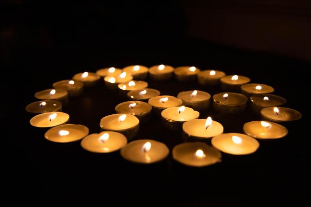 candles arranged in the shape of a peace symbol