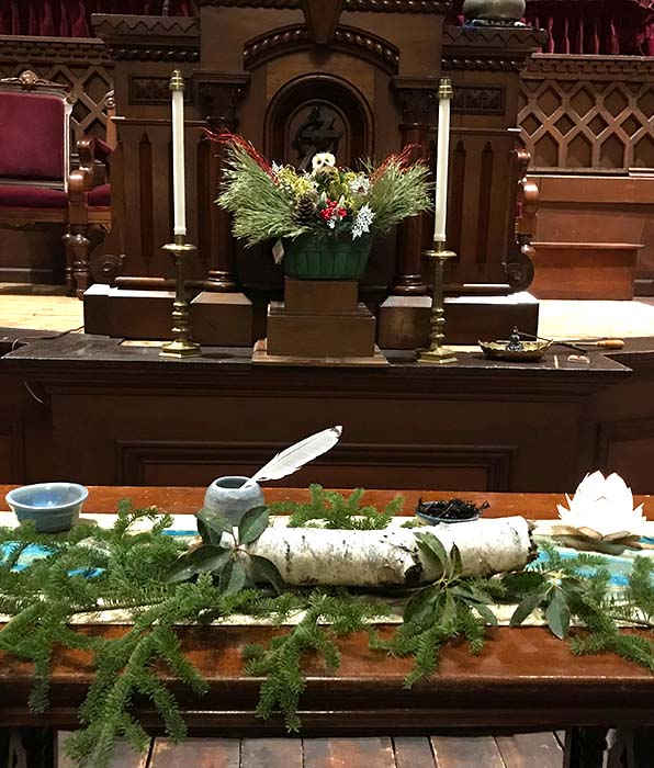 church altar decorated with evergreen branches for christmas