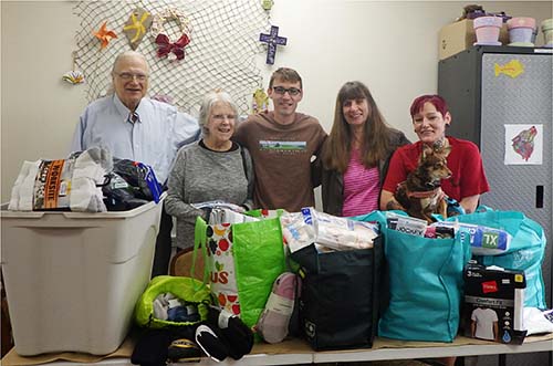 people packaging up a sock and underwear clothing drive